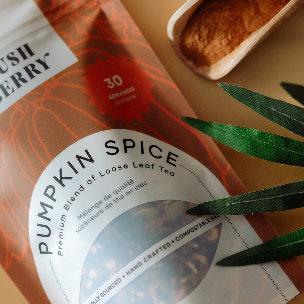 Pumpkin spice tea package with leaves on a warm-toned background