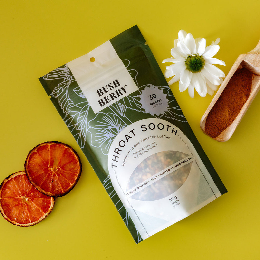 Bush Berry Throat Sooth tea package with dried orange slices and a white flower on a yellow background