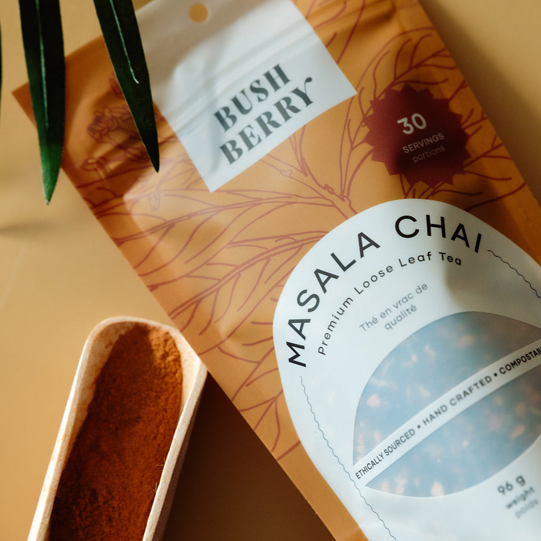 Packaging of Bush Berry Masala Chai tea with a scoop of tea.