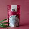 Packaging of Bush Berry Organic Wild Raspberry Hibiscus Tea on a pink background