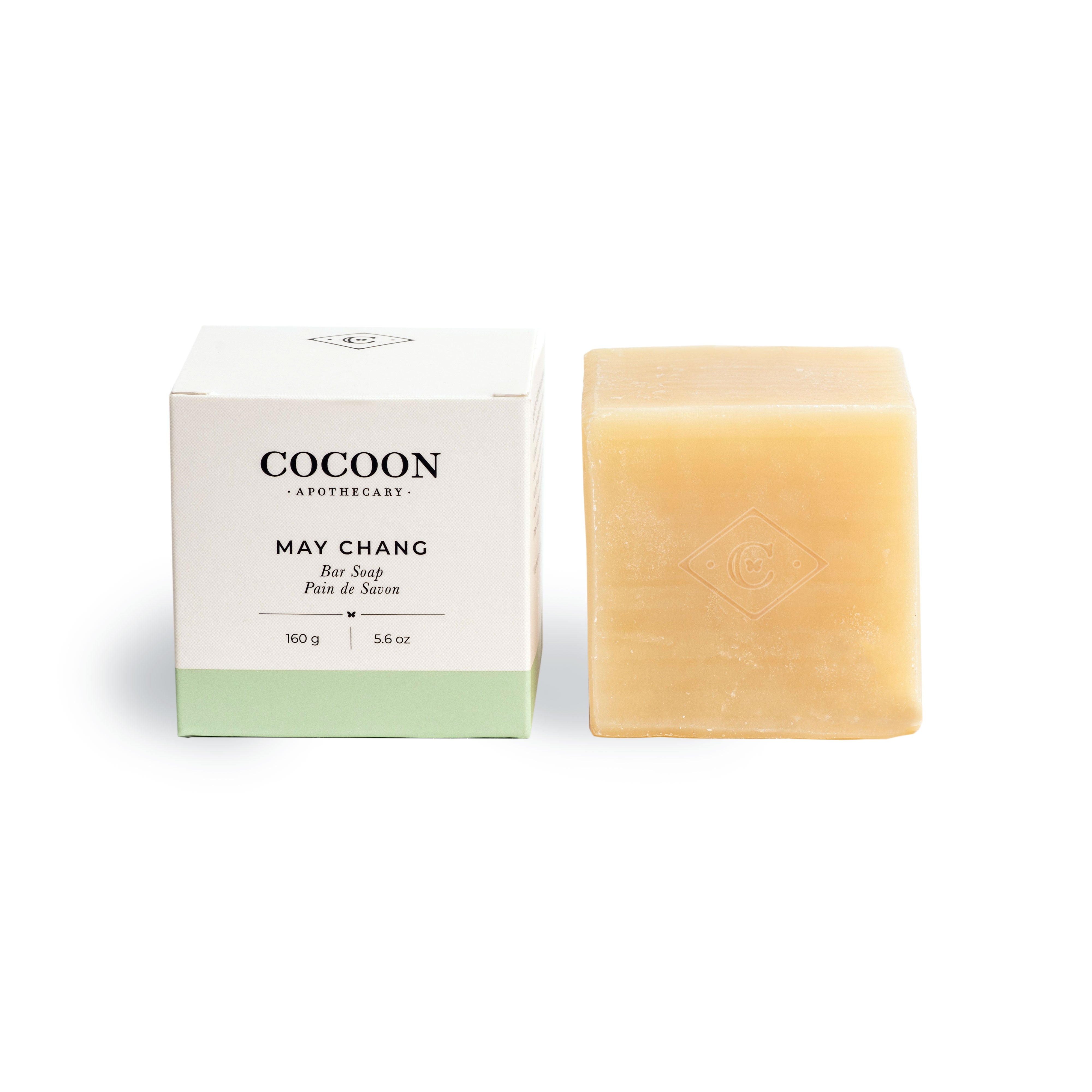 Bar of soap next to its packaging with 'Cocoon Apothecary' branding on a white background