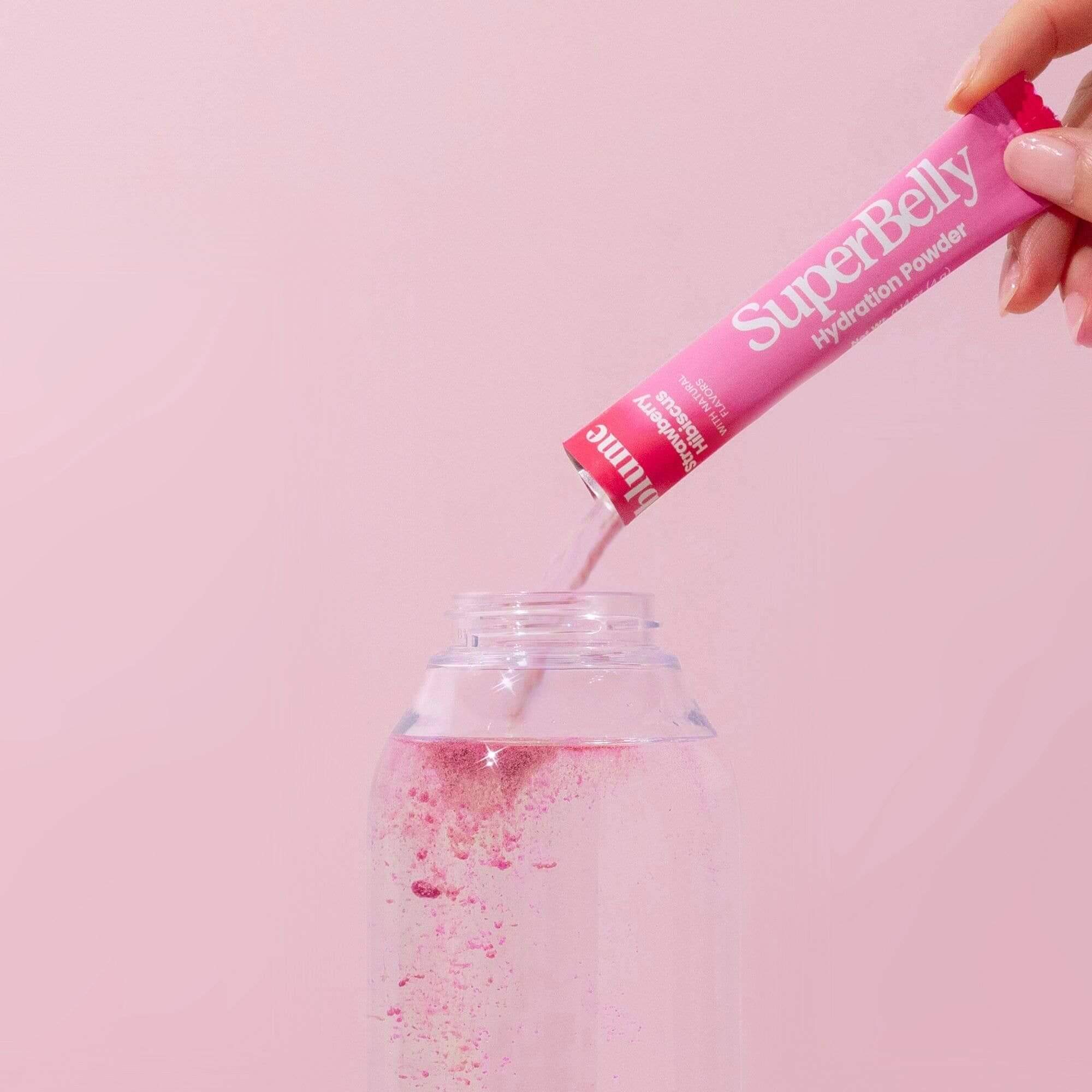 SuperBelly hydration drink powder in Strawberry Hibiscus pour in a glass
