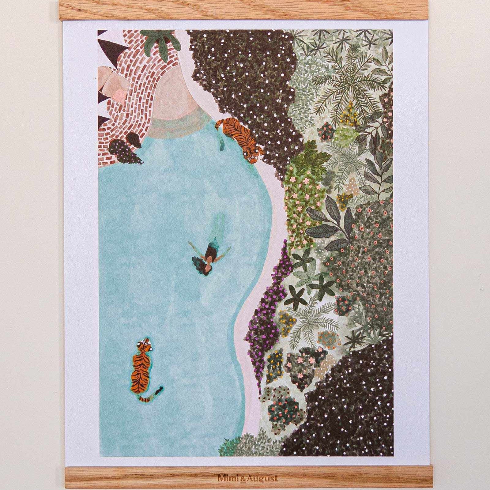 Framed artwork with a woman in a blue dress surrounded by nature elements on a white wall.