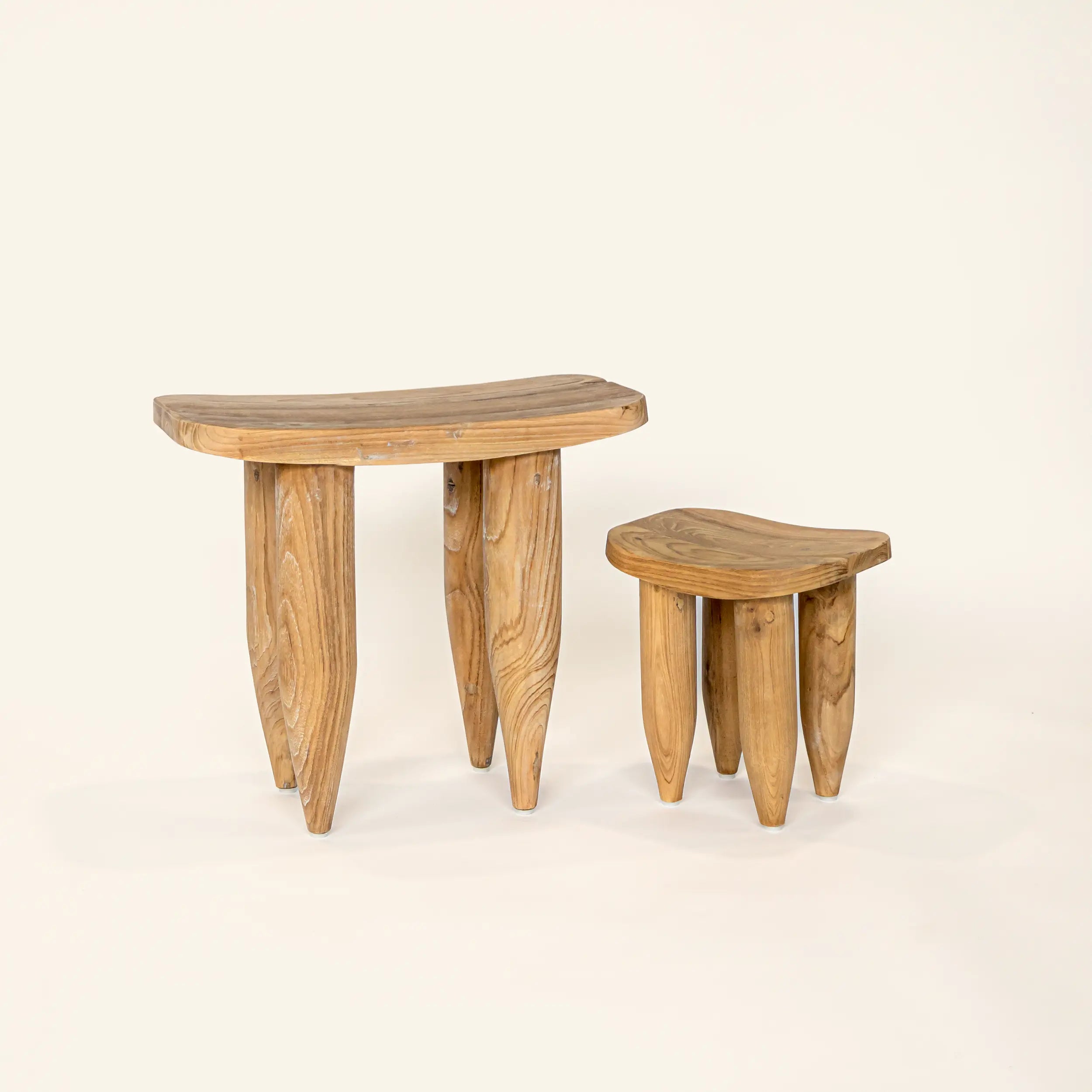 Two wooden stools on a beige background