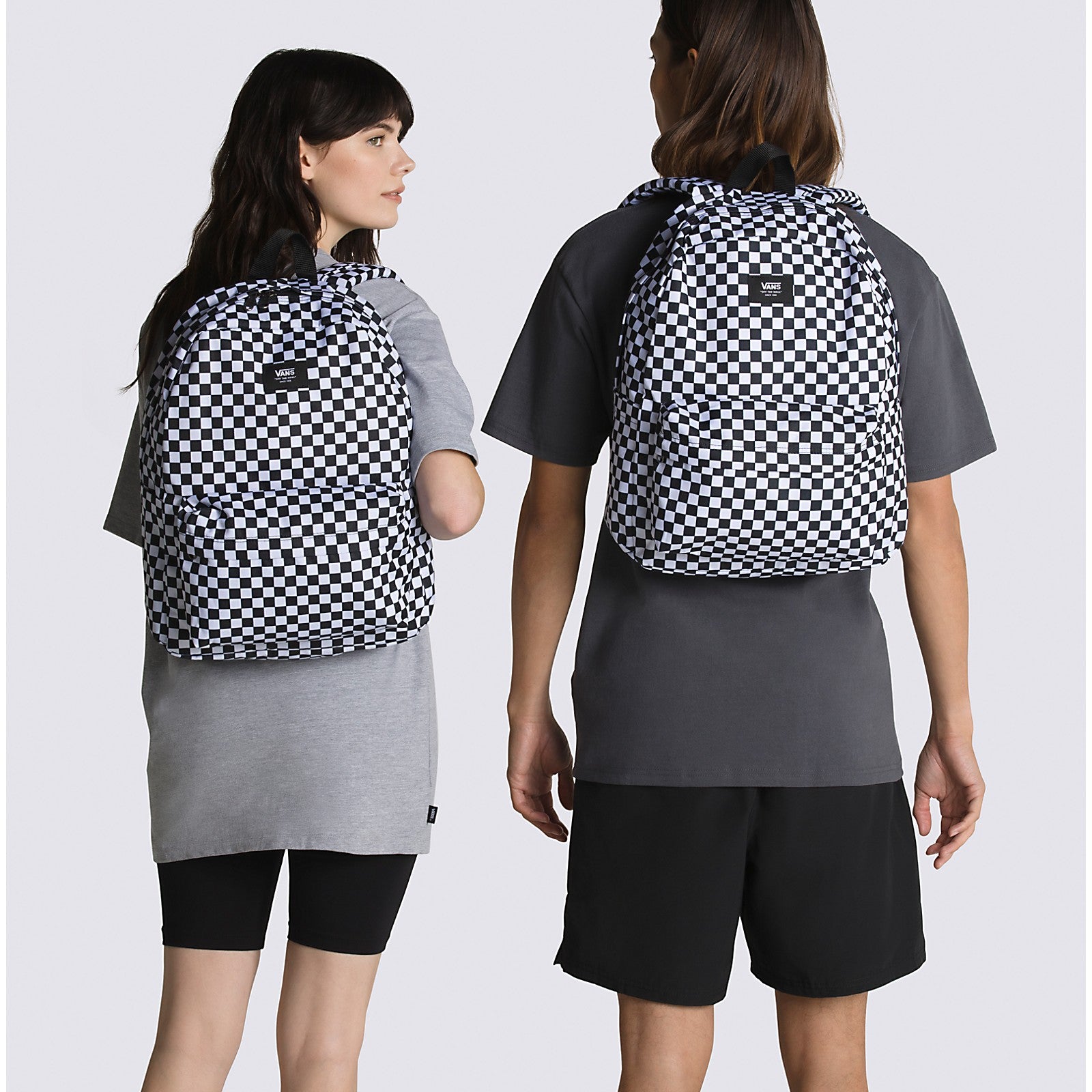 Vans Old Skool H2O Check Backpack showcased on two models, featuring a classic checkerboard pattern.