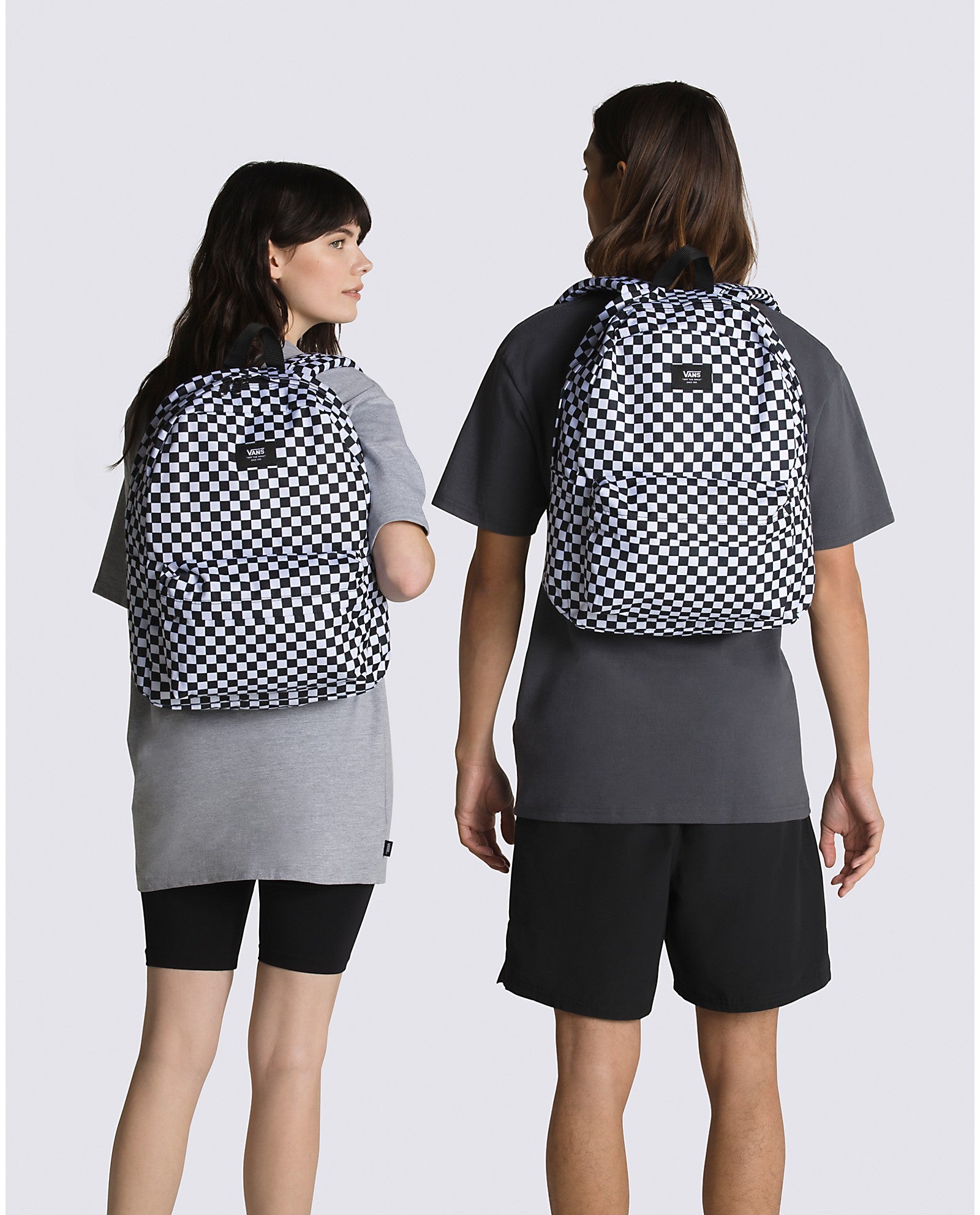 Vans Old Skool H2O Check Backpack showcased on two models, featuring a classic checkerboard pattern.