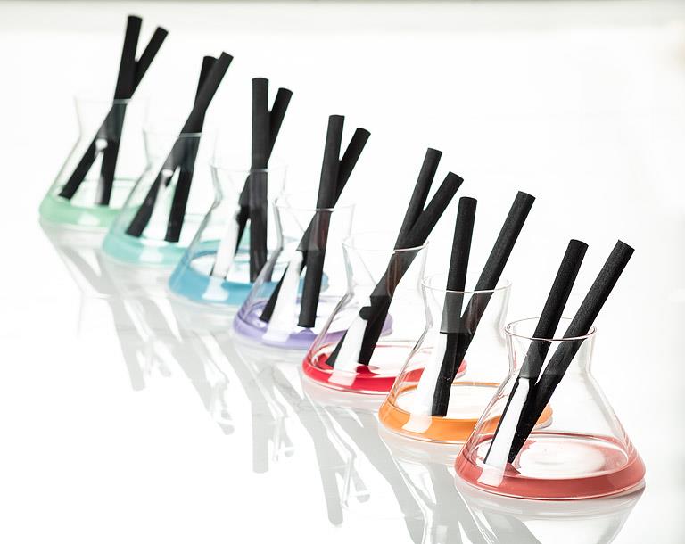 Set of colorful Vivid reed diffuser collection with black straws on a white background
