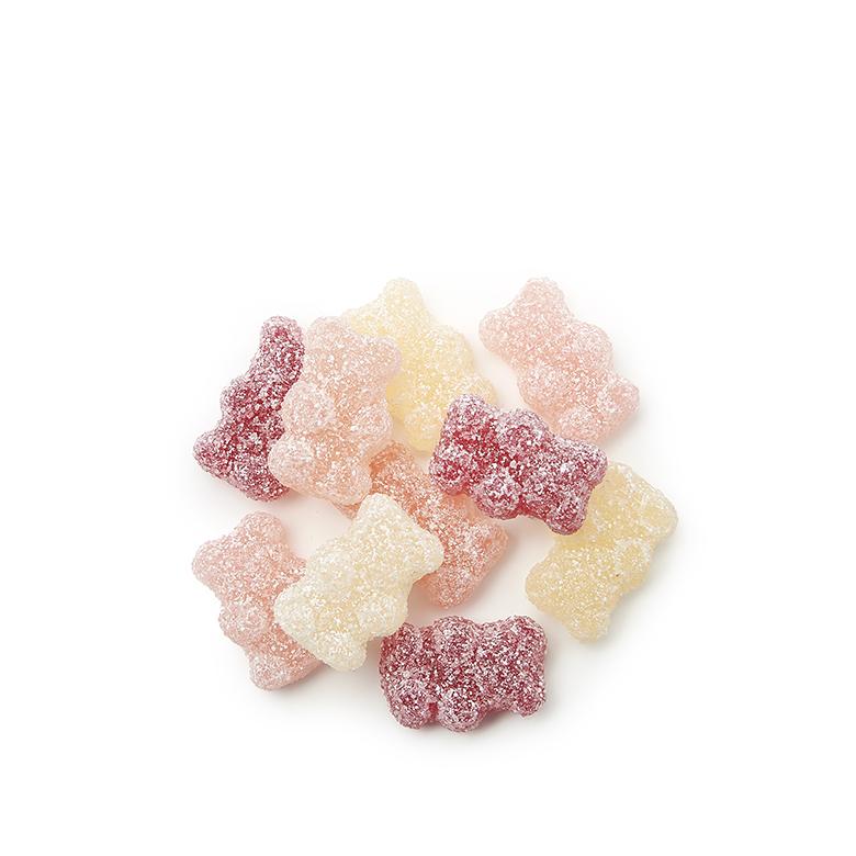 Assorted colored gummy bears on a white background