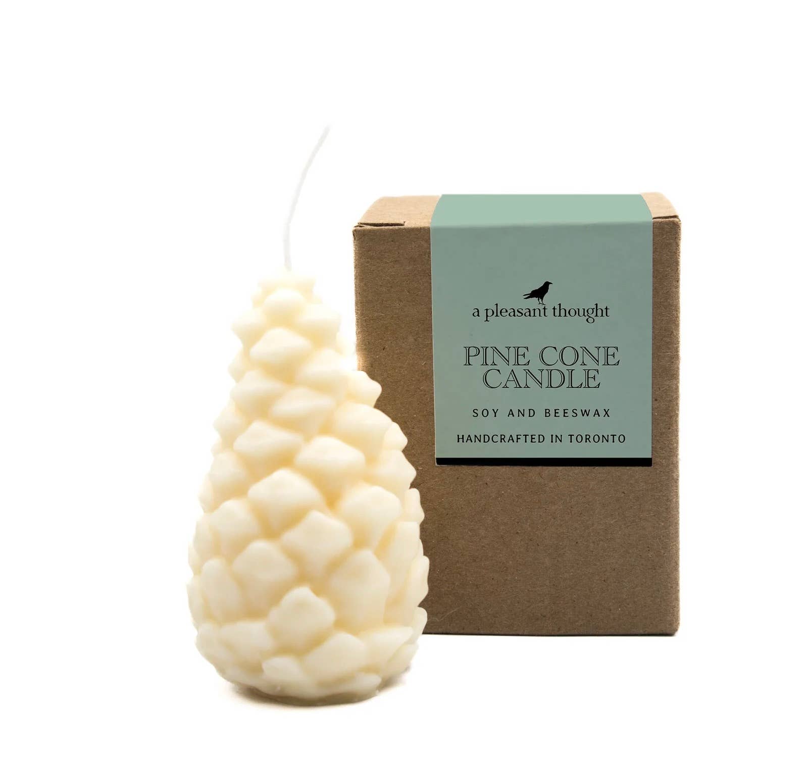 White pillar candle in pinecone shape with box