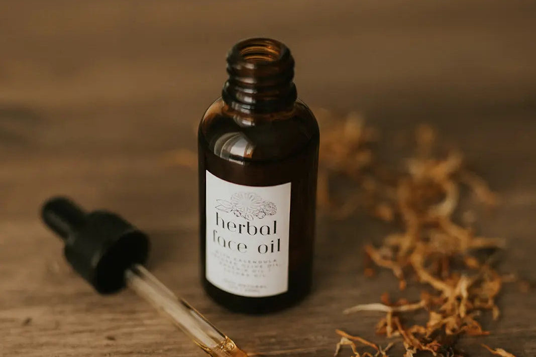 Bottle of herbal face oil with dropper on a wooden surface