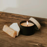 Candle and soap on a wooden surface with a neutral background