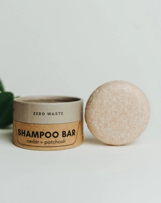 Shampoo bar and container with 'Zero Waste' label on a light background
