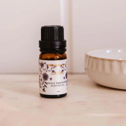 Azalée scented oil by Mimi & August, Calming floral diffuser oil with white tea and jasmine with floral label on a wooden surface