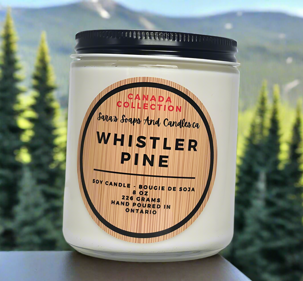 Candle with 'Whistler Pine' label against a forest background
