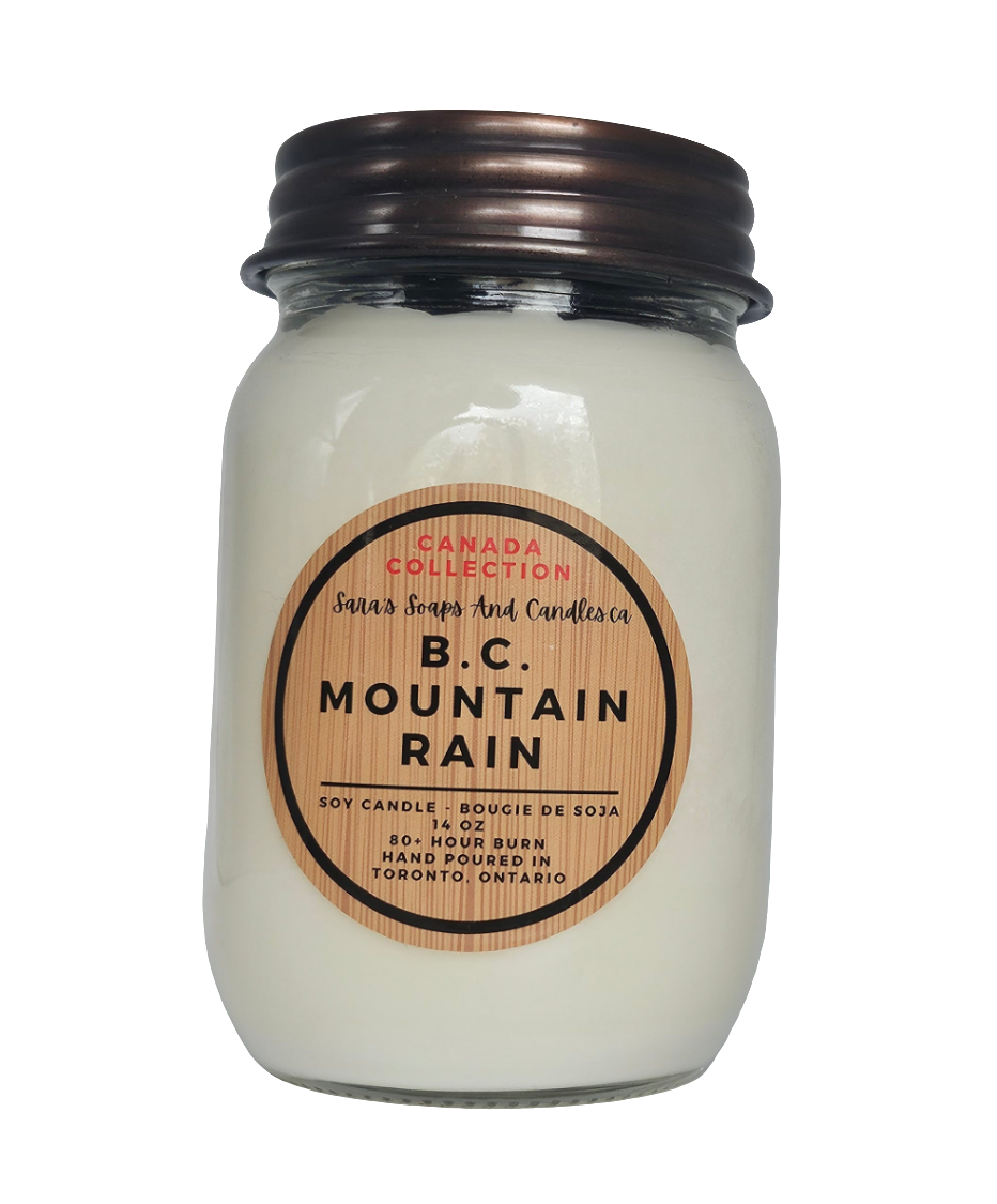 Jar candle labeled 'B.C. Mountain Rain' with a wooden label on a white background