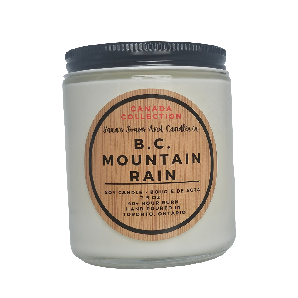 Candle jar labeled 'B.C. Mountain Rain' from Canada Collection on a white background