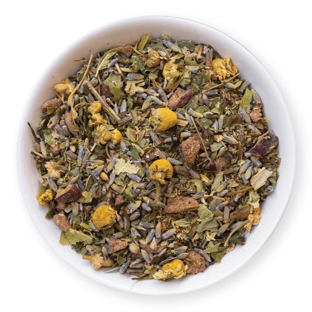 Herbal tea mix with various herbs and flowers in a white bowl on a dark background