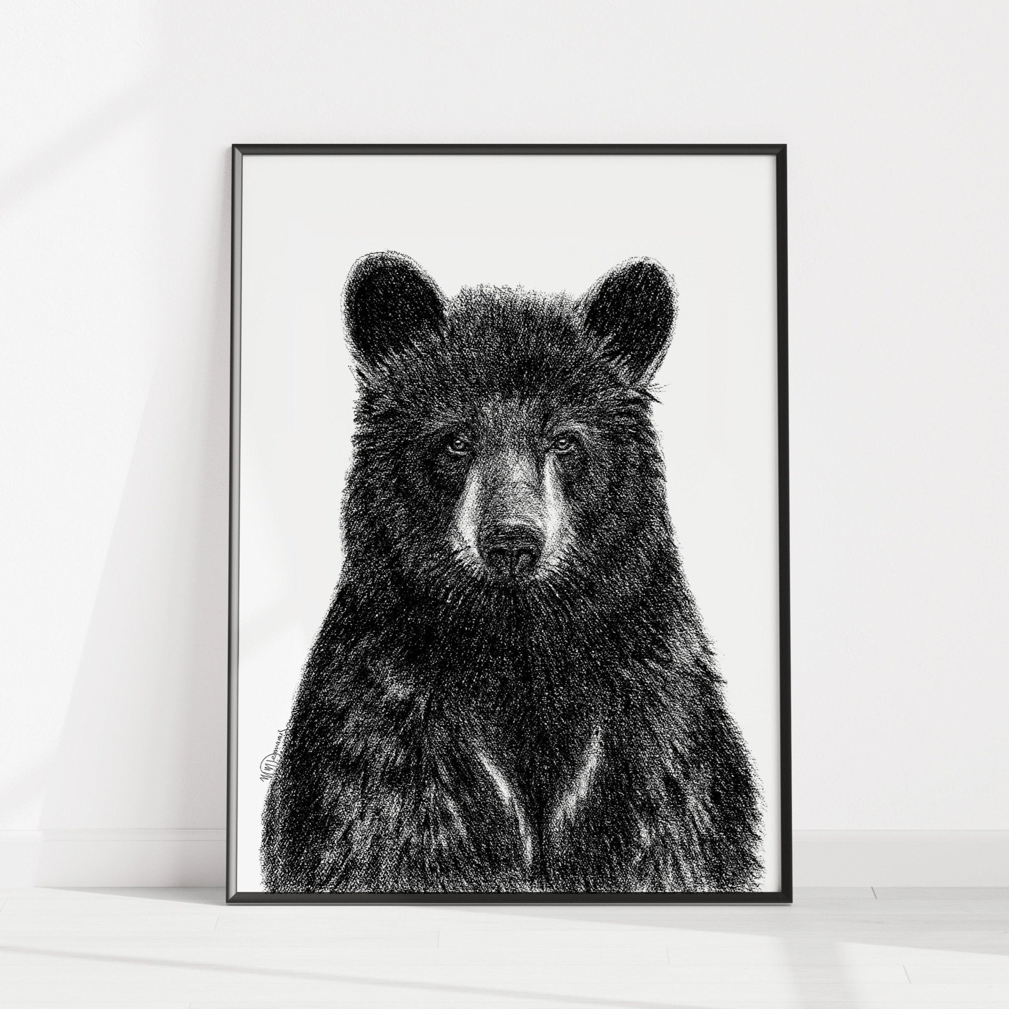 Framed black and white bear illustration on a white wall