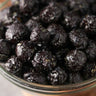 close view of a Bowl of candied black cherry popcorn on a wooden surface from Toronto Popcorn company