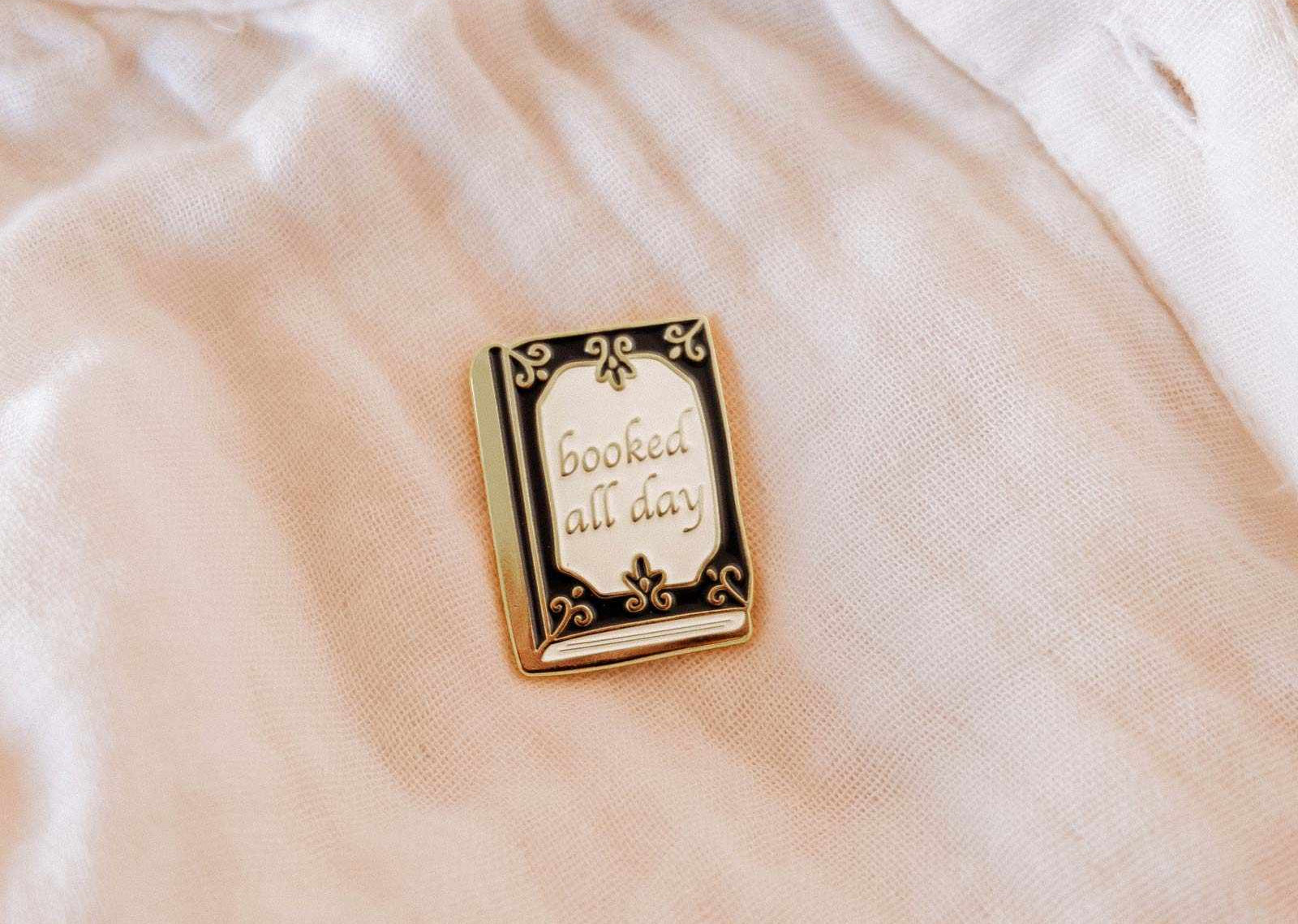 Pin with 'booked all day' text on a light-colored fabric background mimi-and-august