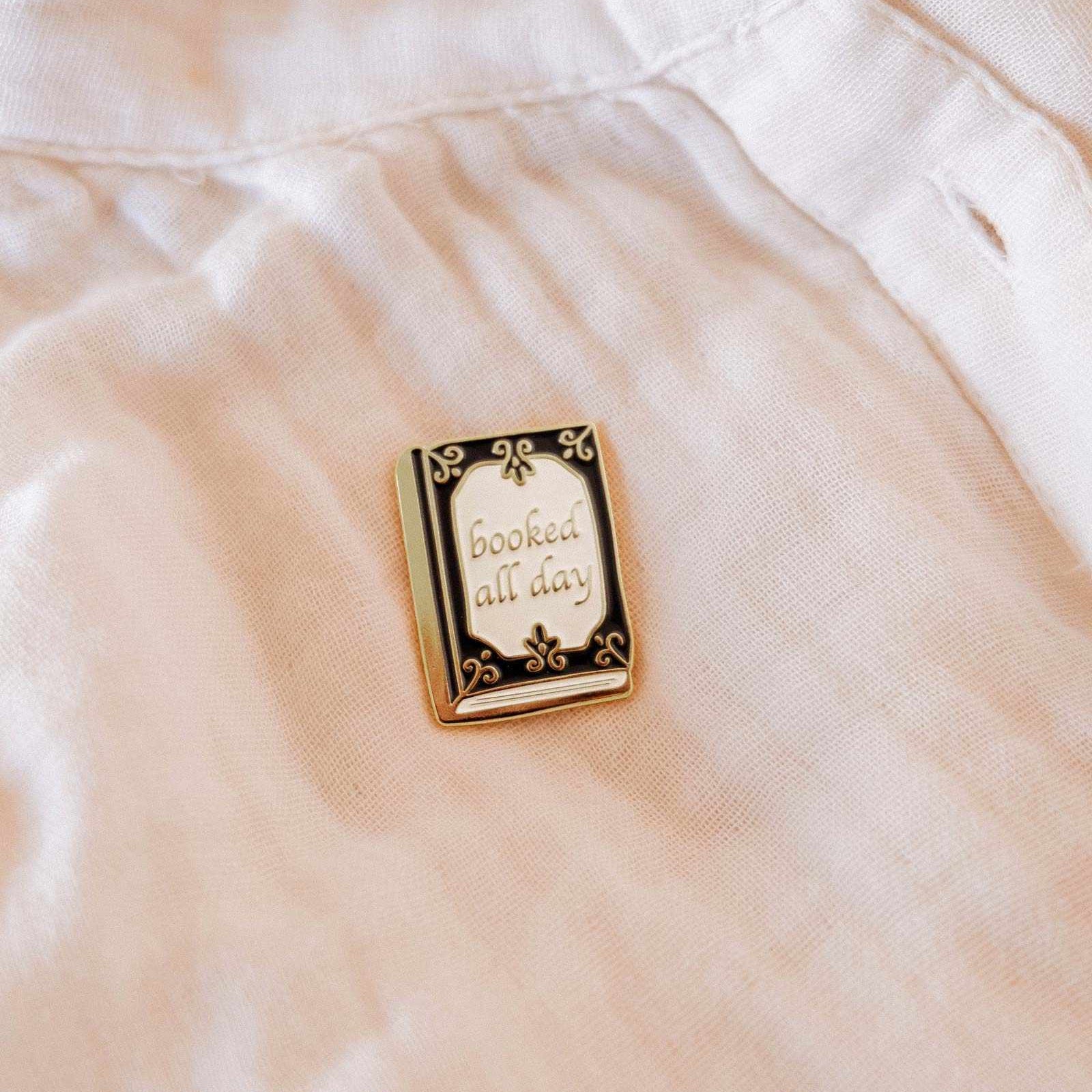 Pin with 'booked all day' text on a light-colored fabric background mimi-and-august