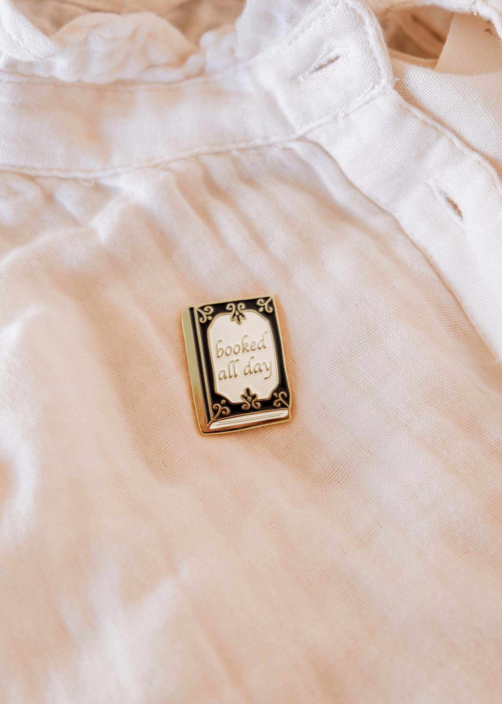 Pin with 'booked all day' text on a light-colored fabric background mimi-and-august