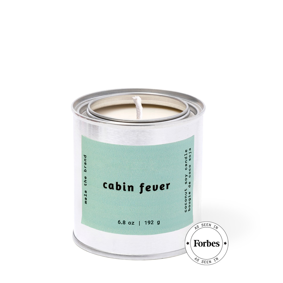 Candle in a metal can with a label reading 'cabin fever' on a white background, featuring the Forbes logo.