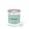 Candle in a metal can with a label reading 'cabin fever' on a white background, featuring the Forbes logo.