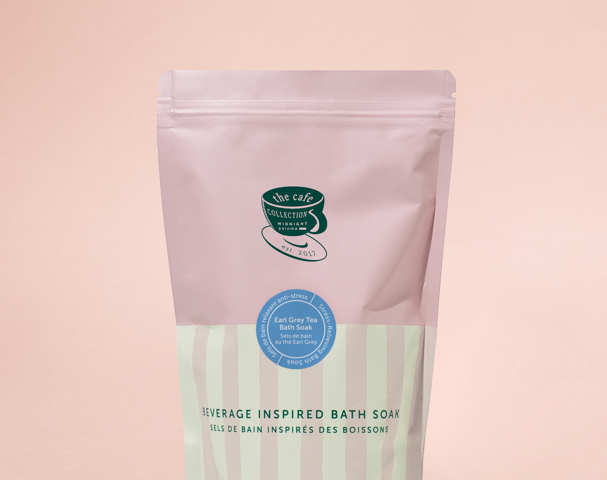 Bath soap package with a pink top and green label on a pink background