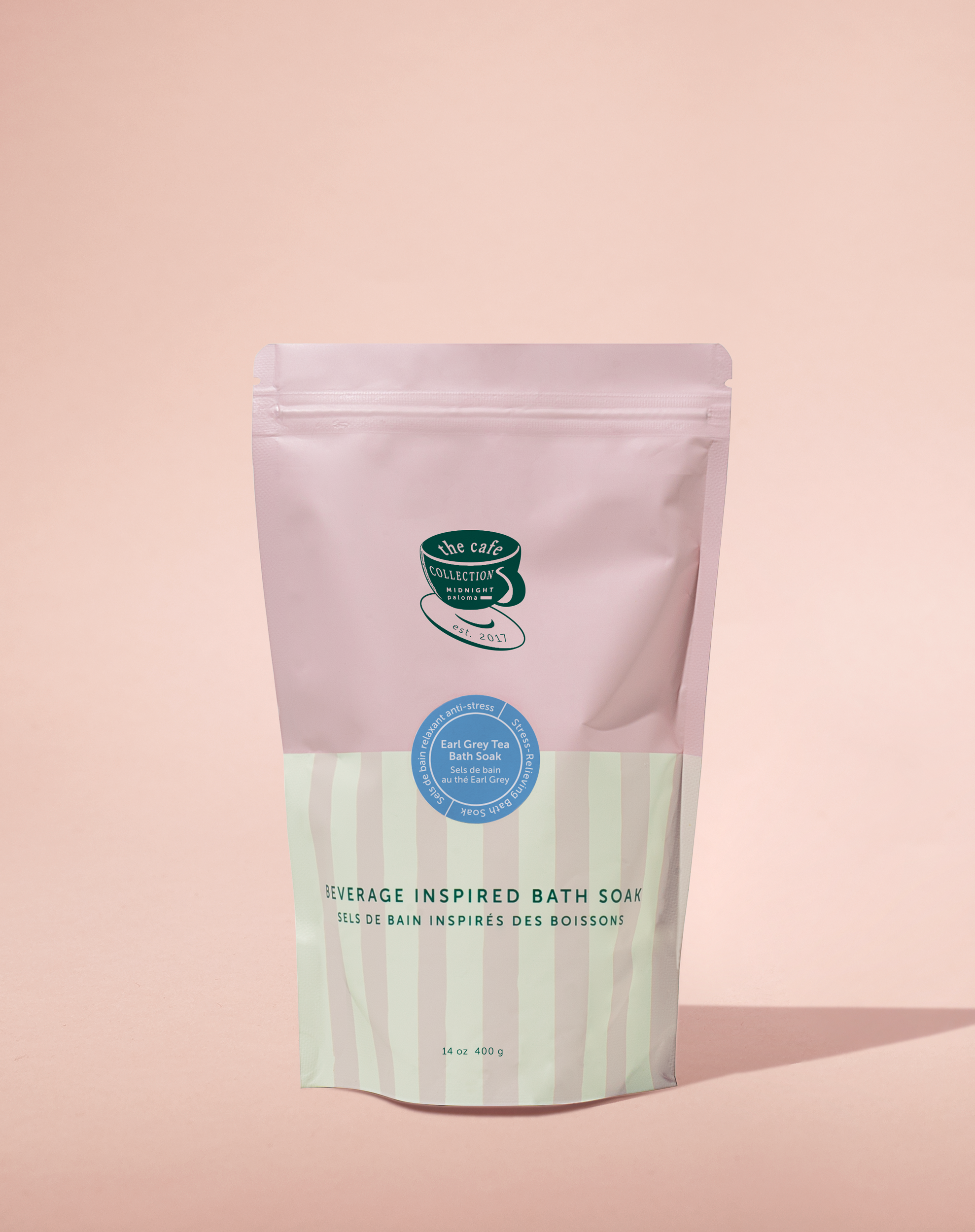 Bath soap package with a pink top and green label on a pink background