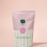 Bath soap package with pink and green design on a pink background