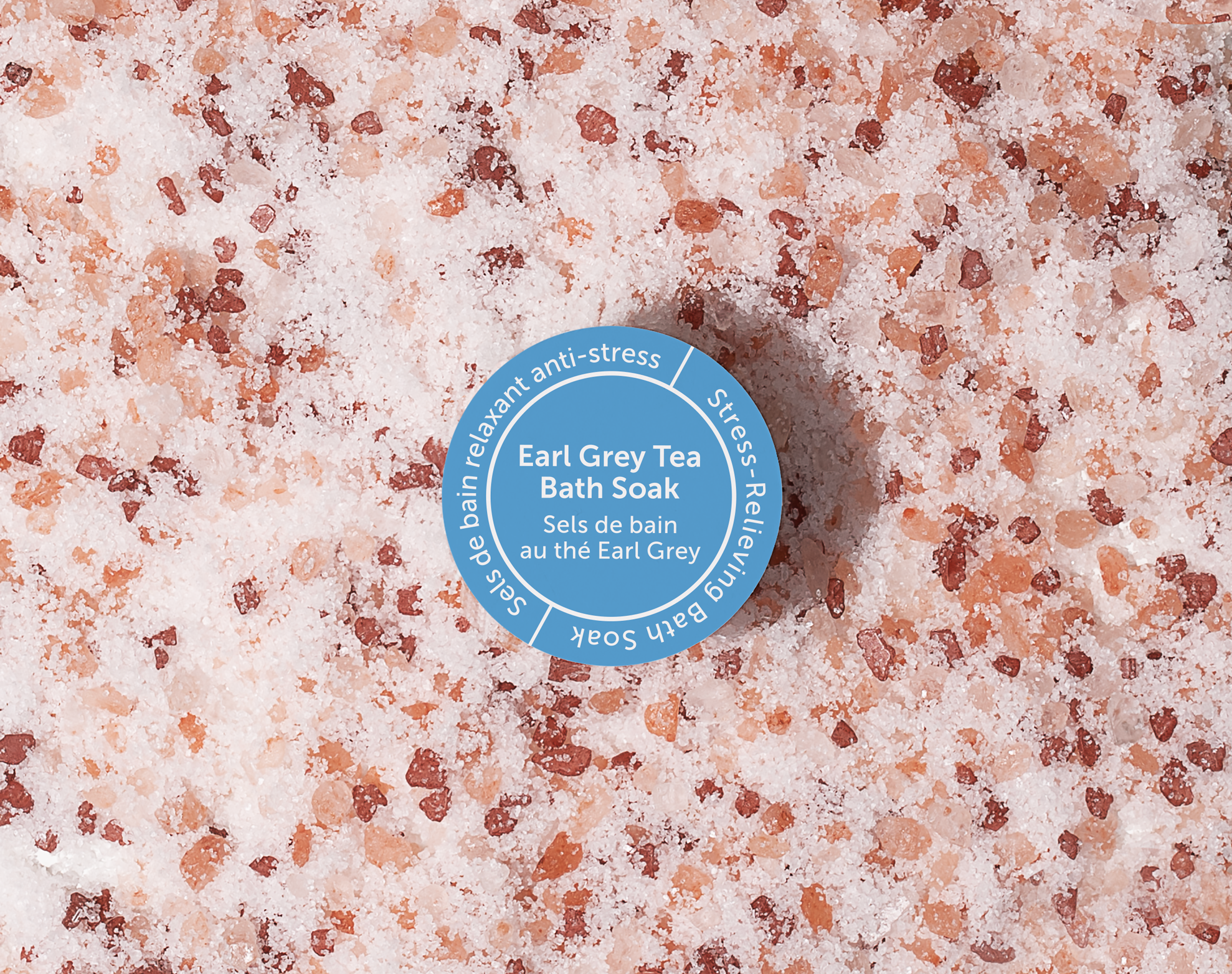 Bottle cap on a pink and brown granular surface