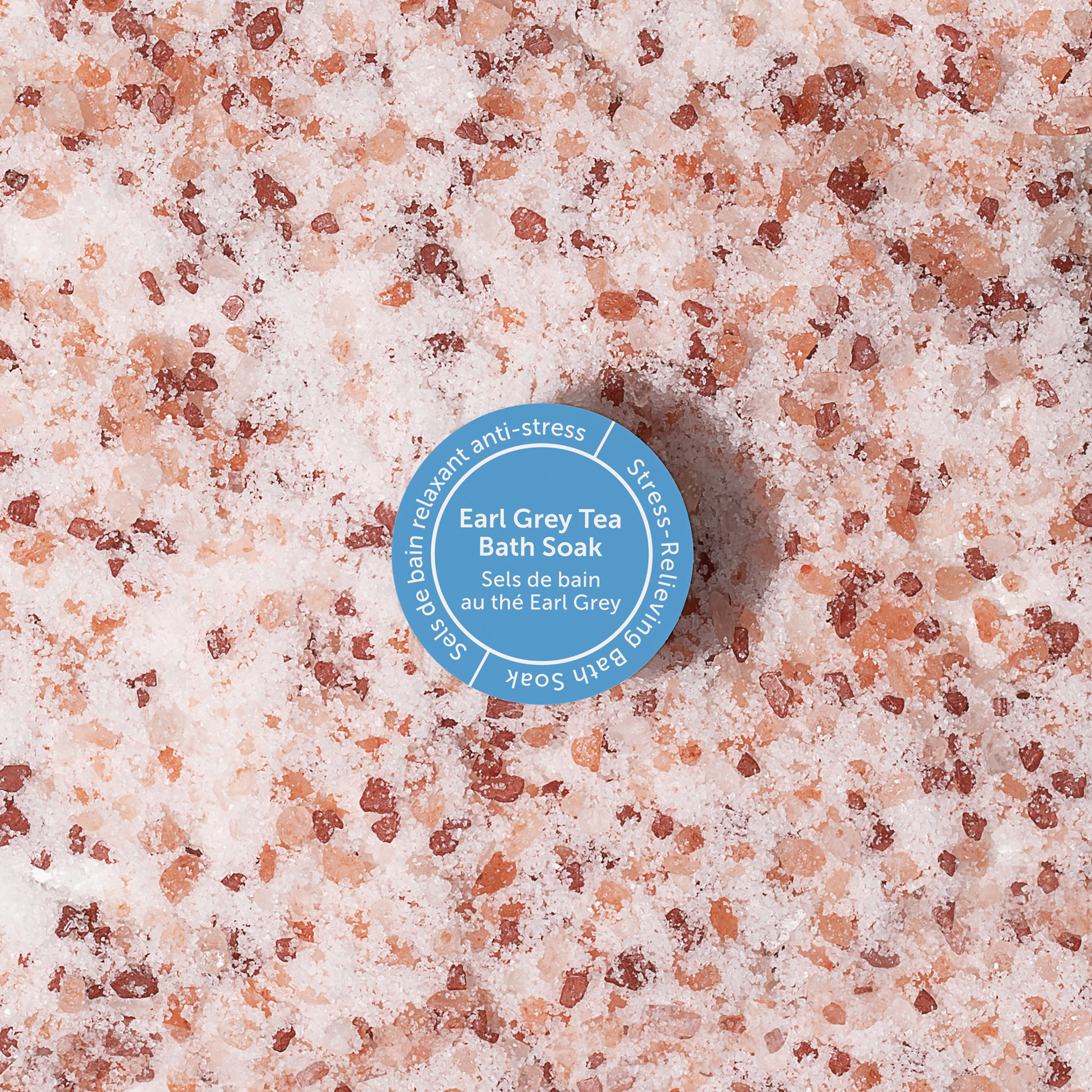 Bottle cap on a pink and brown granular surface