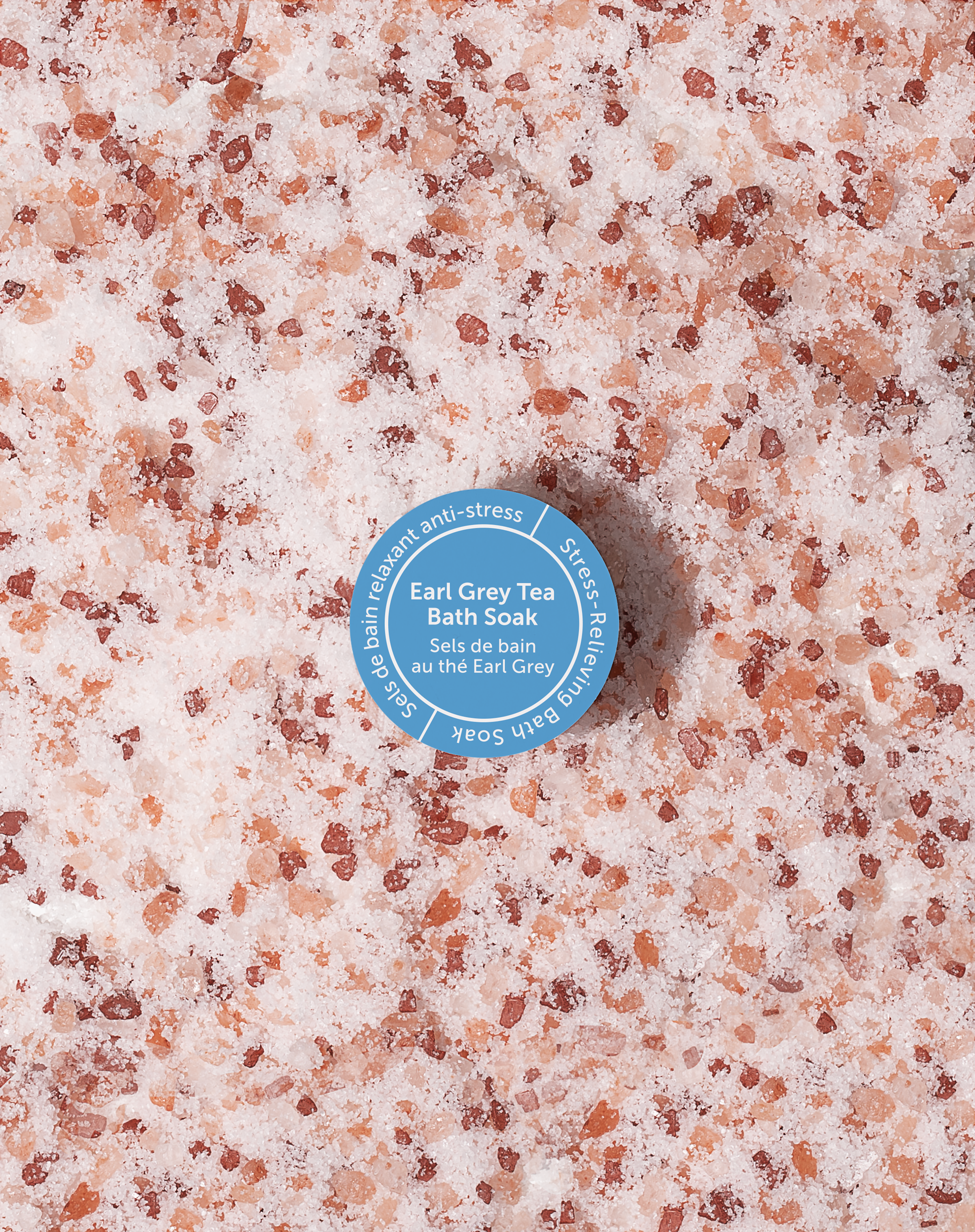 Bottle cap on a pink and brown granular surface