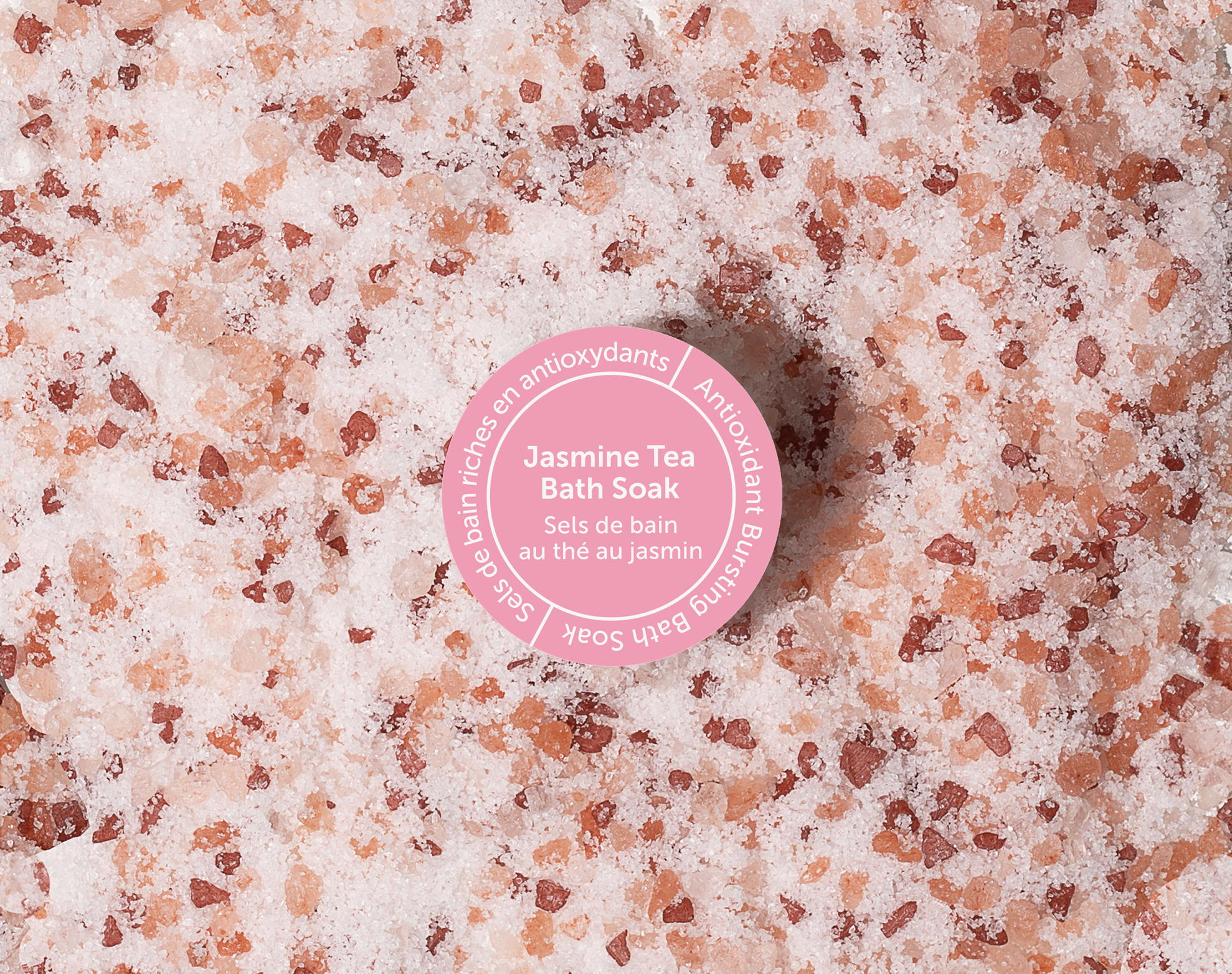 Bath salt with a pink label on a textured surface