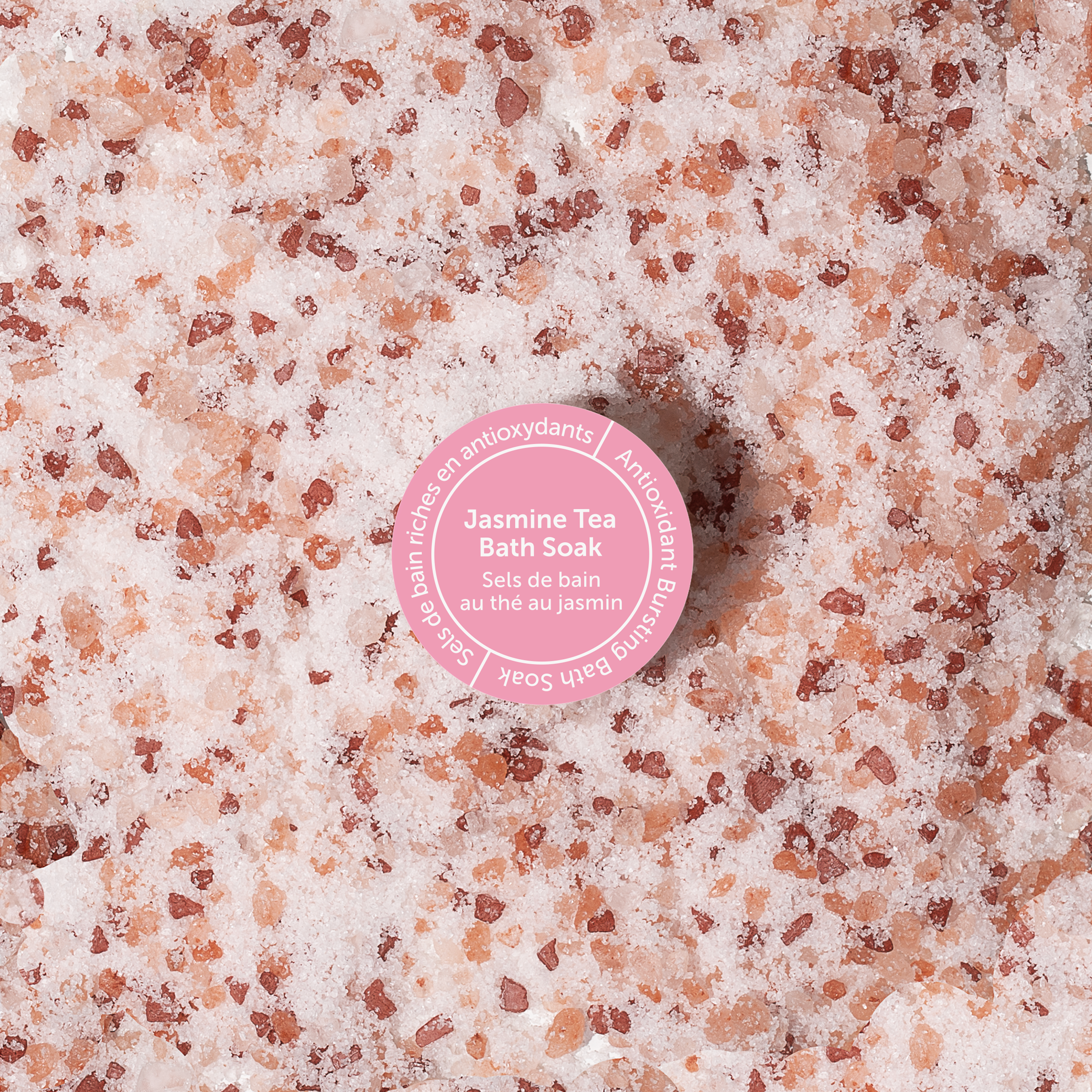 Bath salt with a pink label on a textured surface