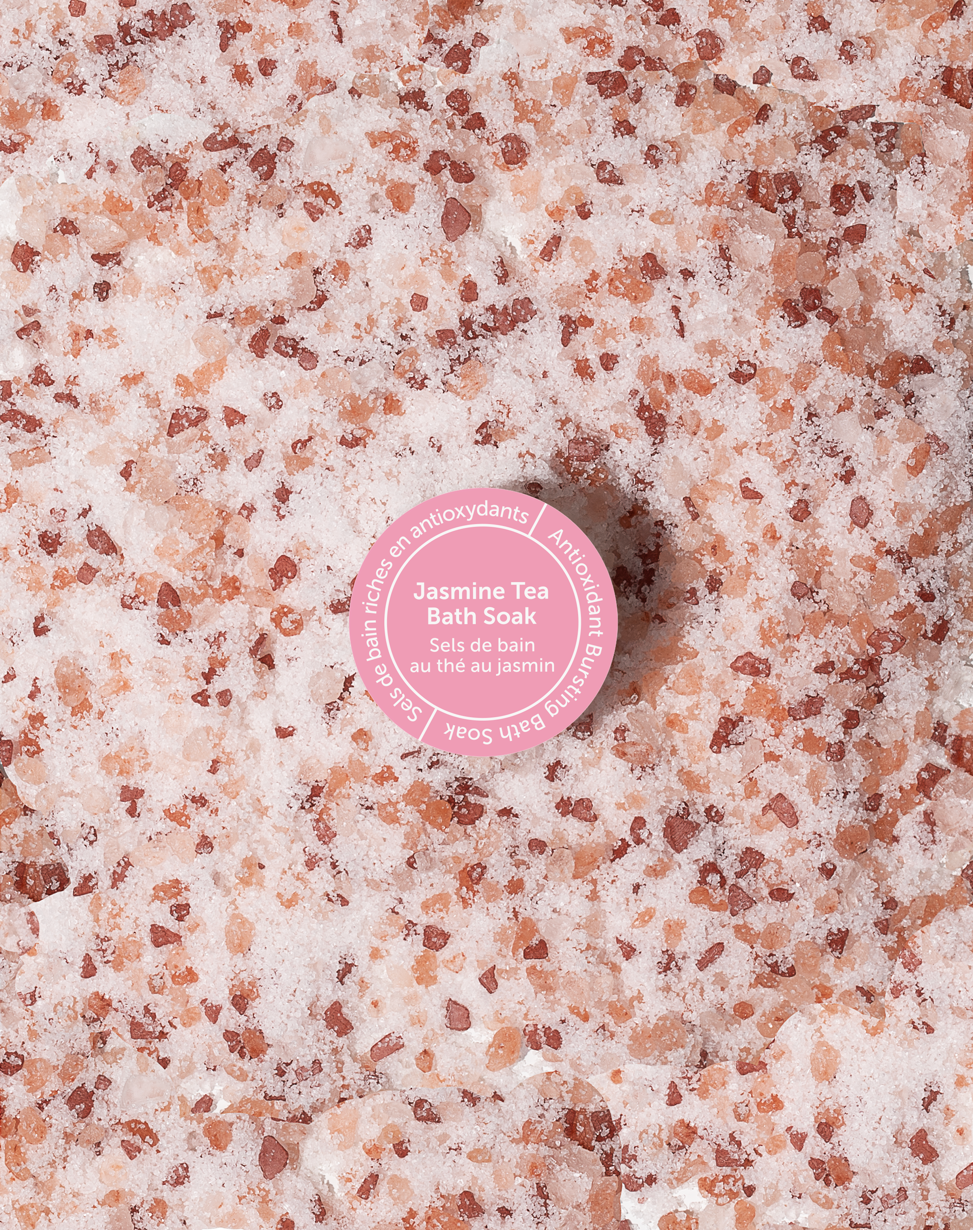 Bath salt with a pink label on a textured surface