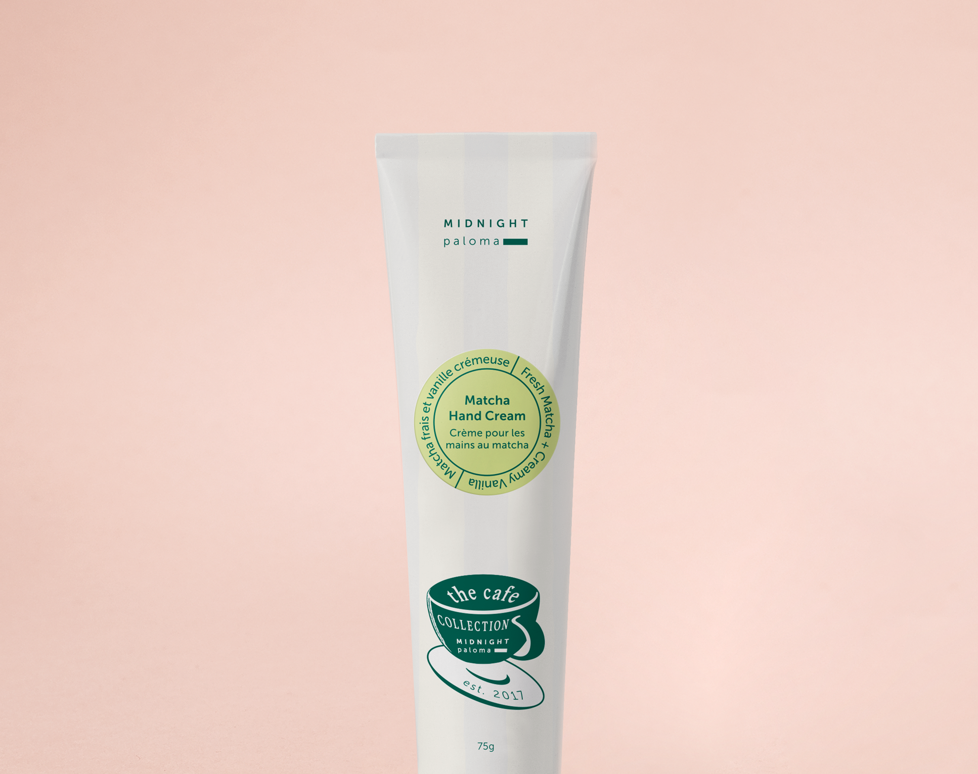 Hand cream tube with green label on a pink background