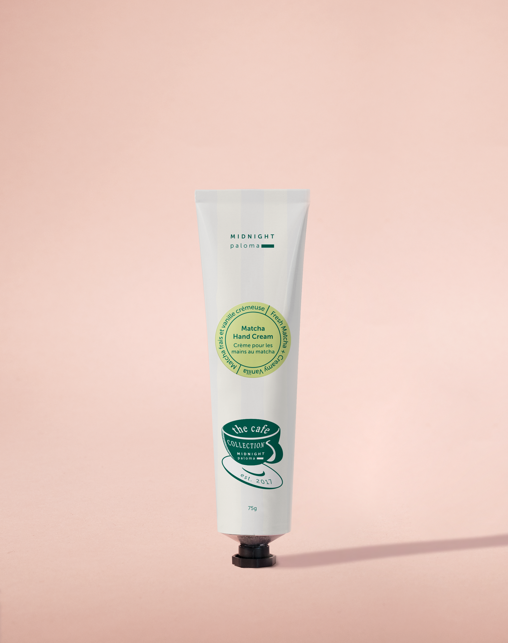 Hand cream tube with green label on a pink background
