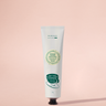 Hand cream tube on a pink background