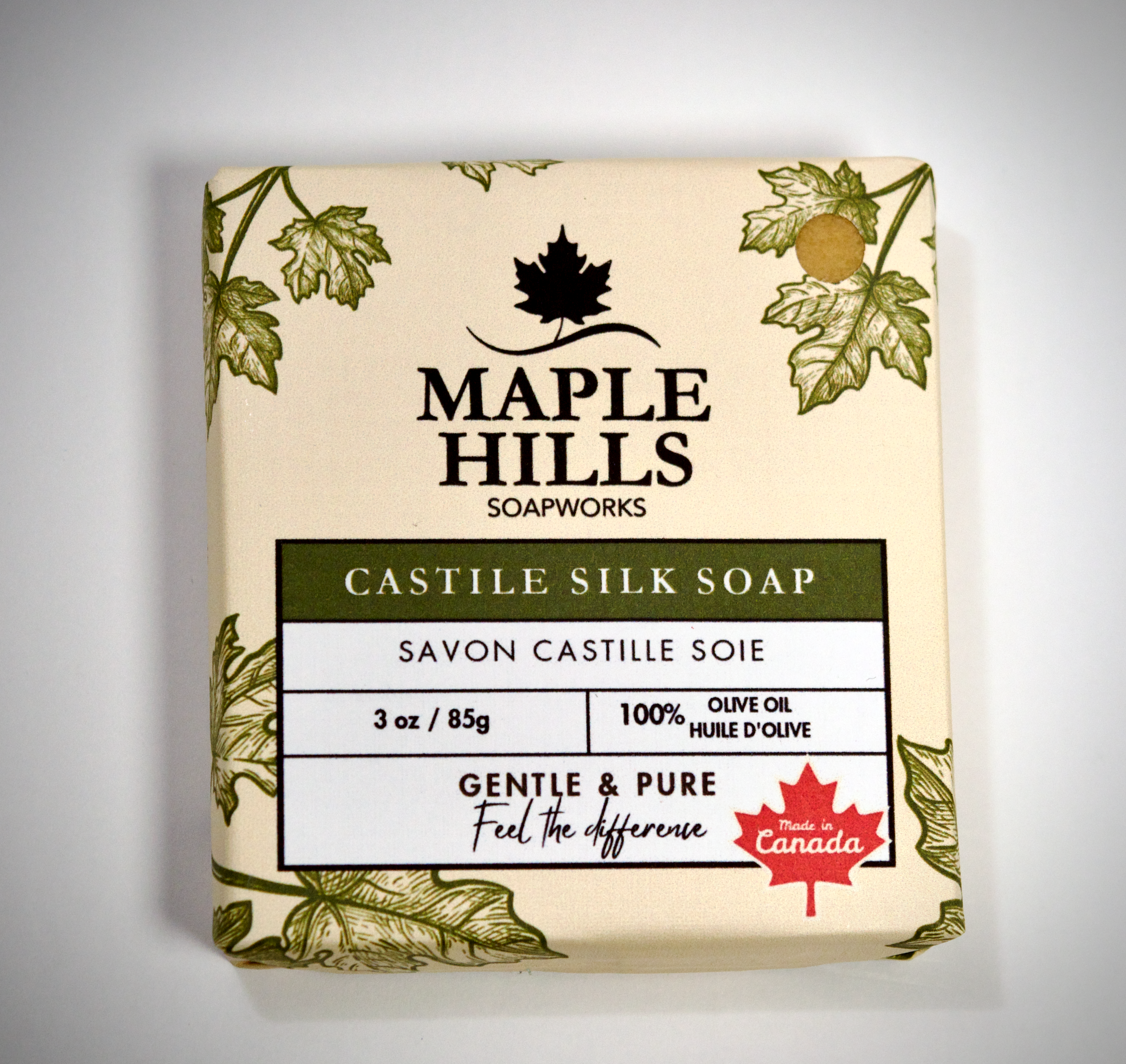Bar of soap from Maple Hills Soapworks with leaf design on a gray background