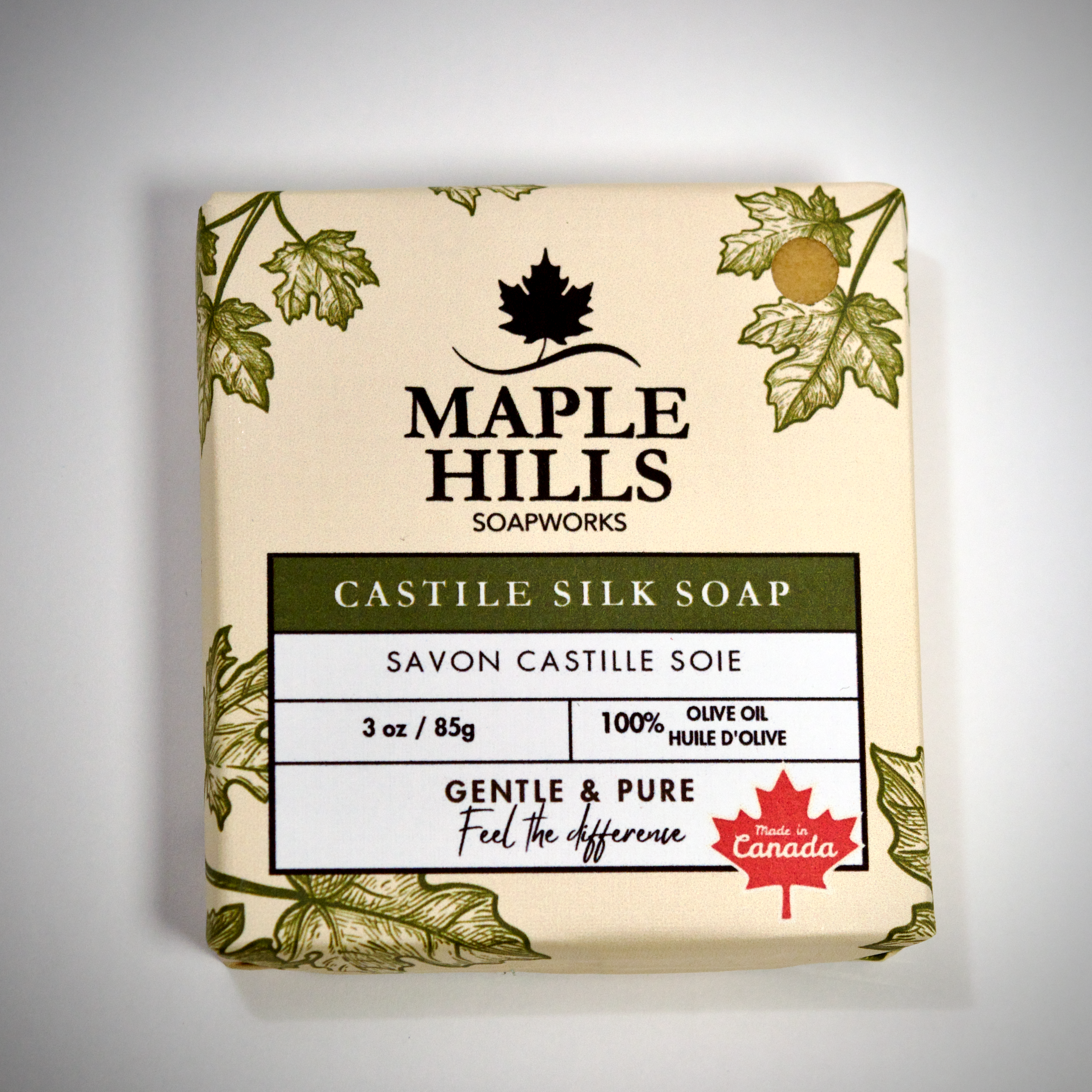 Bar of soap from Maple Hills Soapworks with leaf design on a gray background