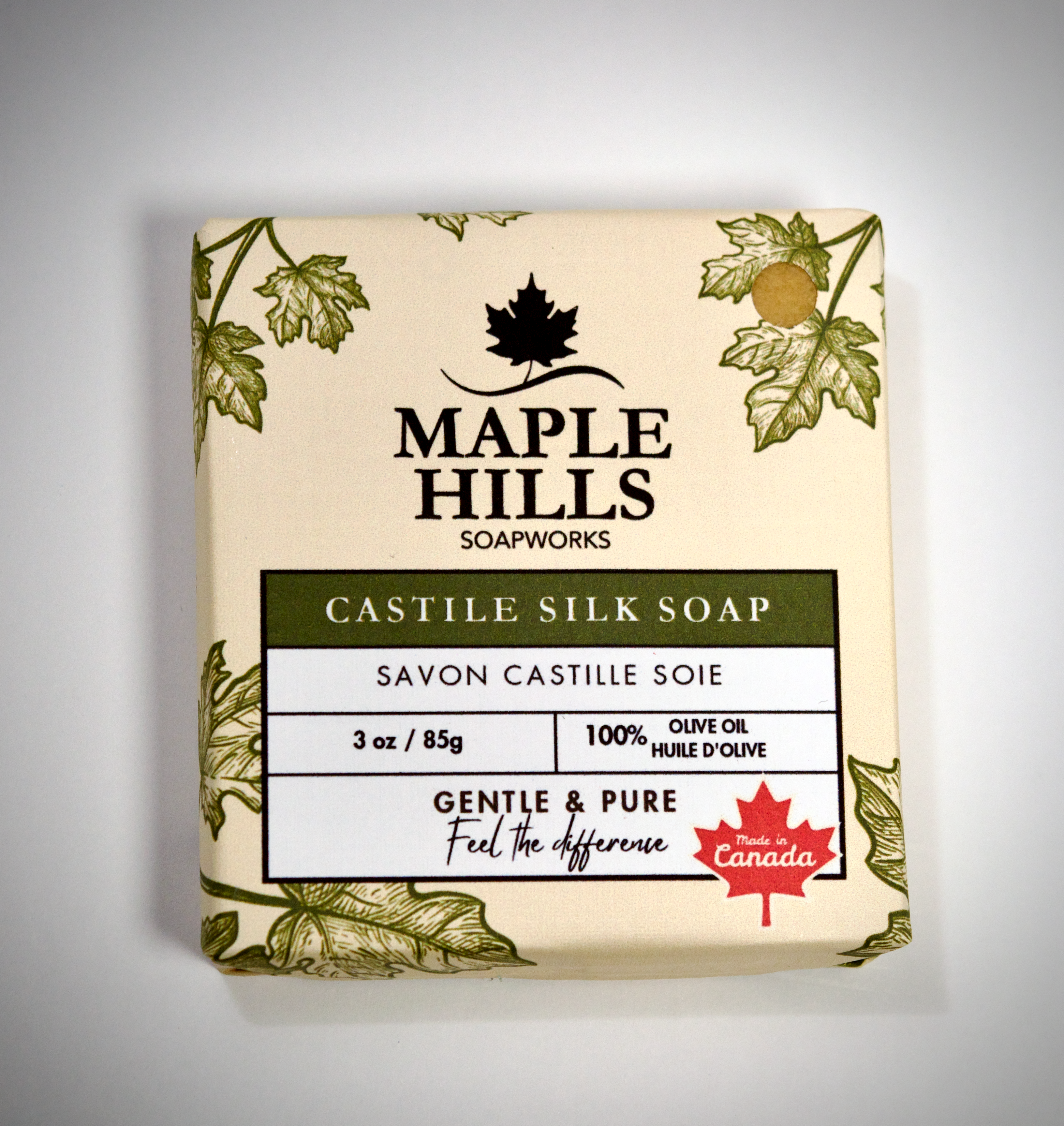 Bar of soap from Maple Hills Soapworks with leaf design on a gray background