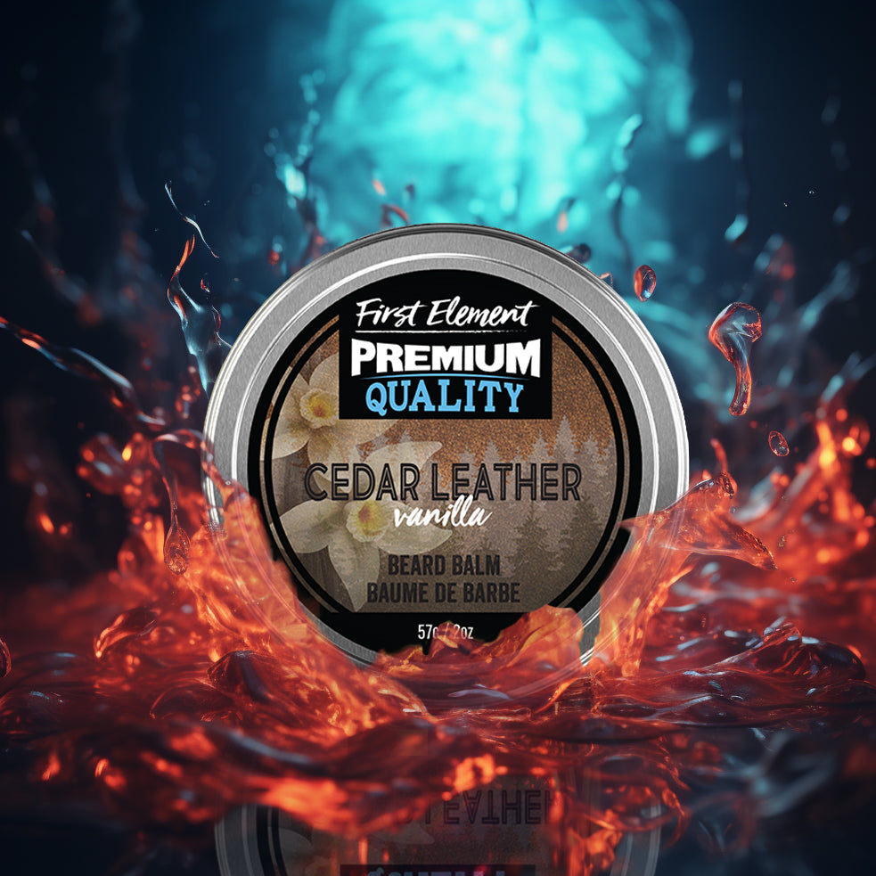 A round tin of First Element Premium Quality Beard Balm in Cedar Leather Vanilla scent, set against a dramatic background of glowing orange liquid splashes and a blue water splash.