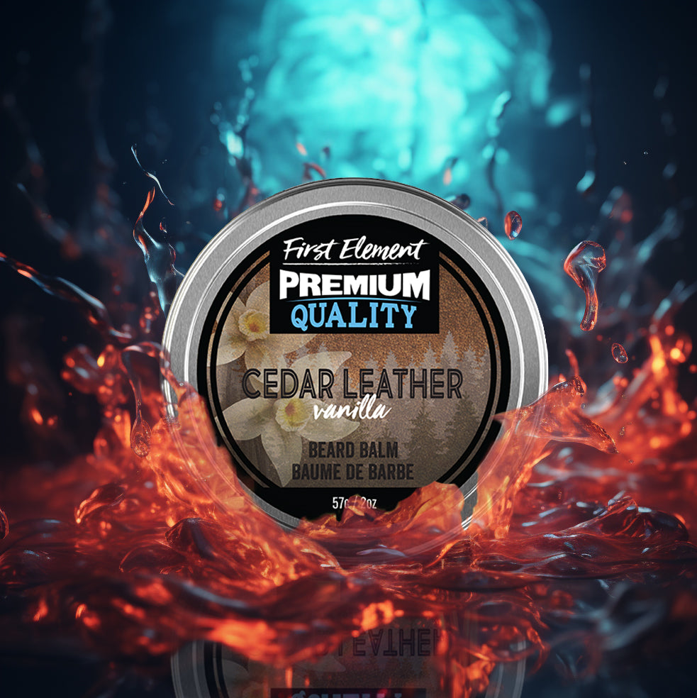 A round tin of First Element Premium Quality Beard Balm in Cedar Leather Vanilla scent, set against a dramatic background of glowing orange liquid splashes and a blue water splash.