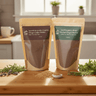 Two packages of organic chaga mocha on a wooden cutting board with herbs in a kitchen setting.