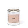 Candle in a metal container with 'chai' label on a white background
