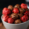 White bowl filled with candied berry and chocolate popcorn from the Toronto Popcorn company