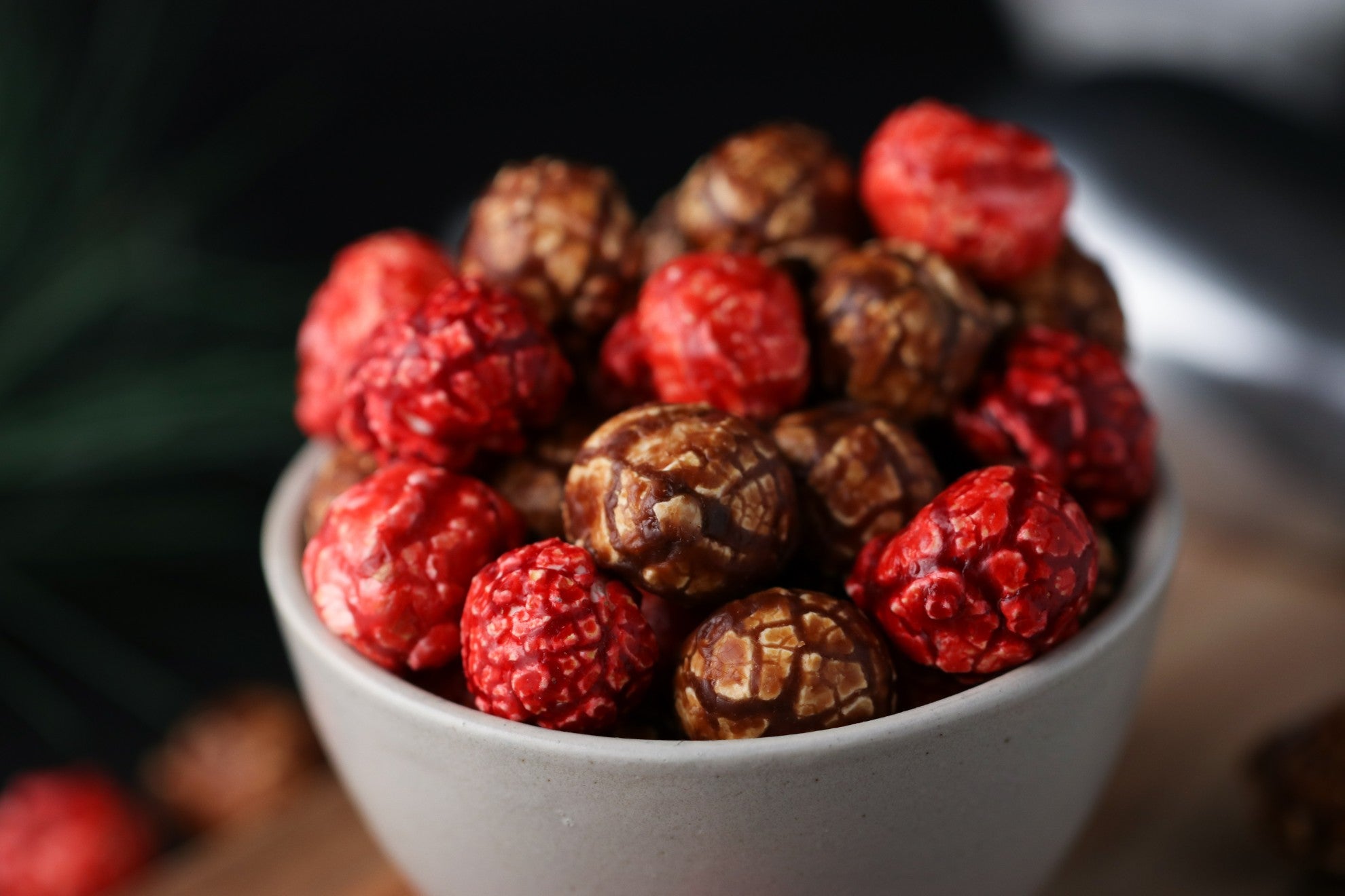 White bowl filled with candied berry and chocolate popcorn from the Toronto Popcorn company