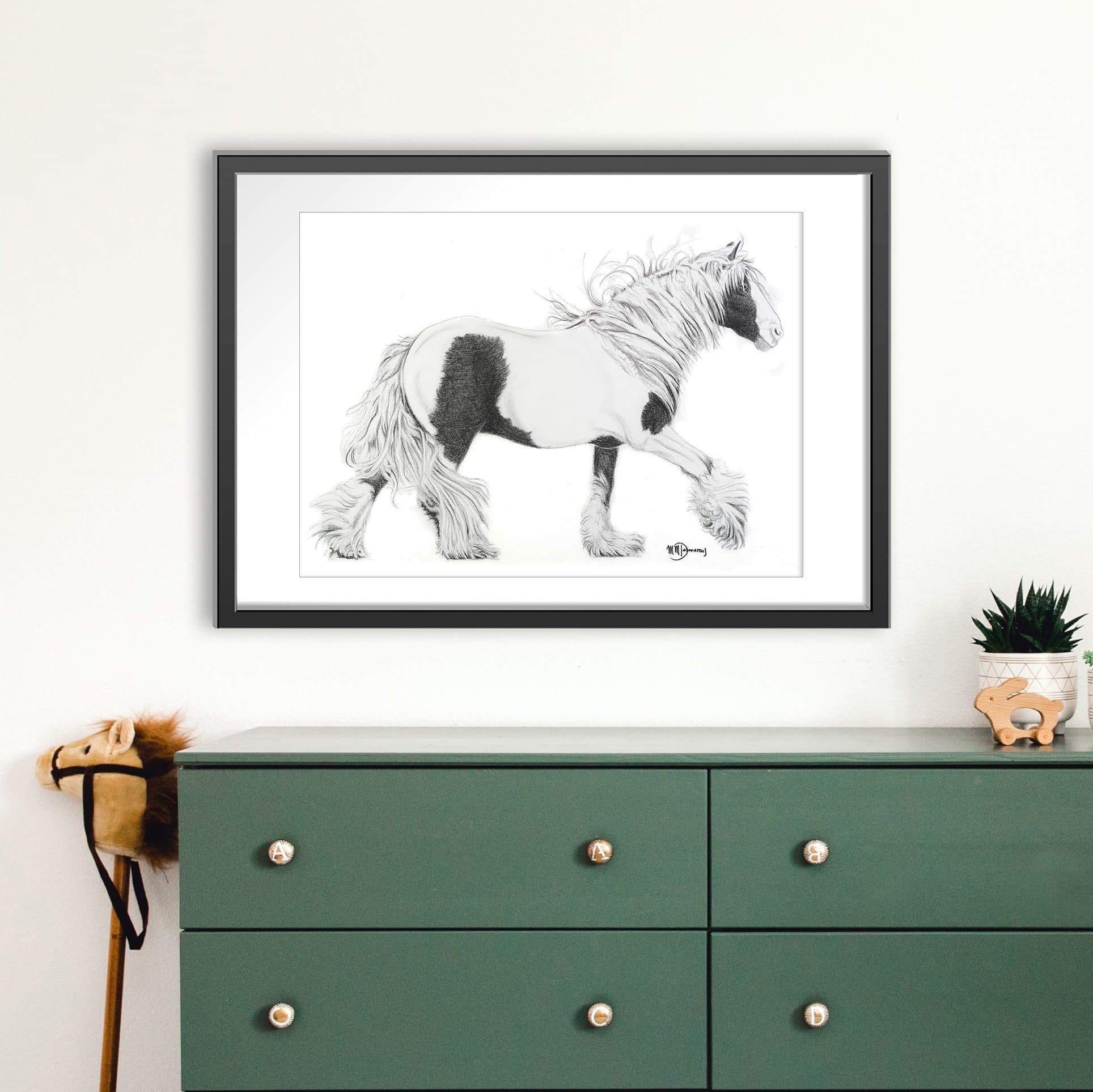Framed black and white horse illustration above a green dresser.